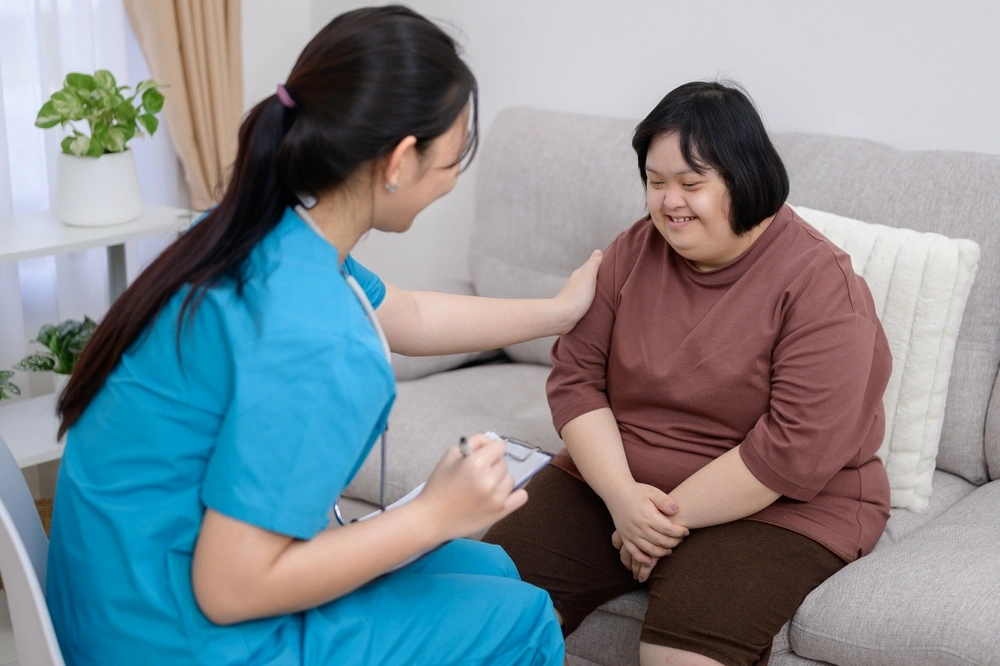 Nurse with a disabled girl with down syndrome