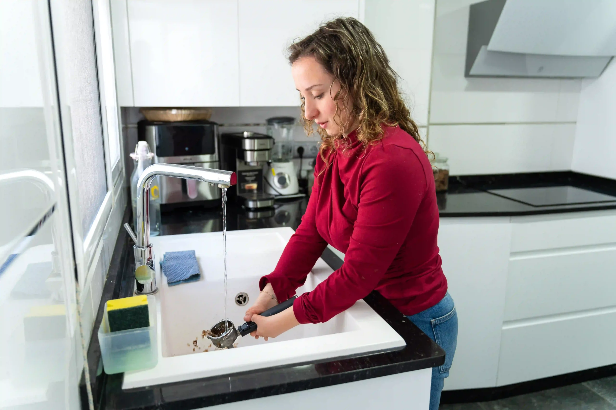 Women washing dishes in kitchen