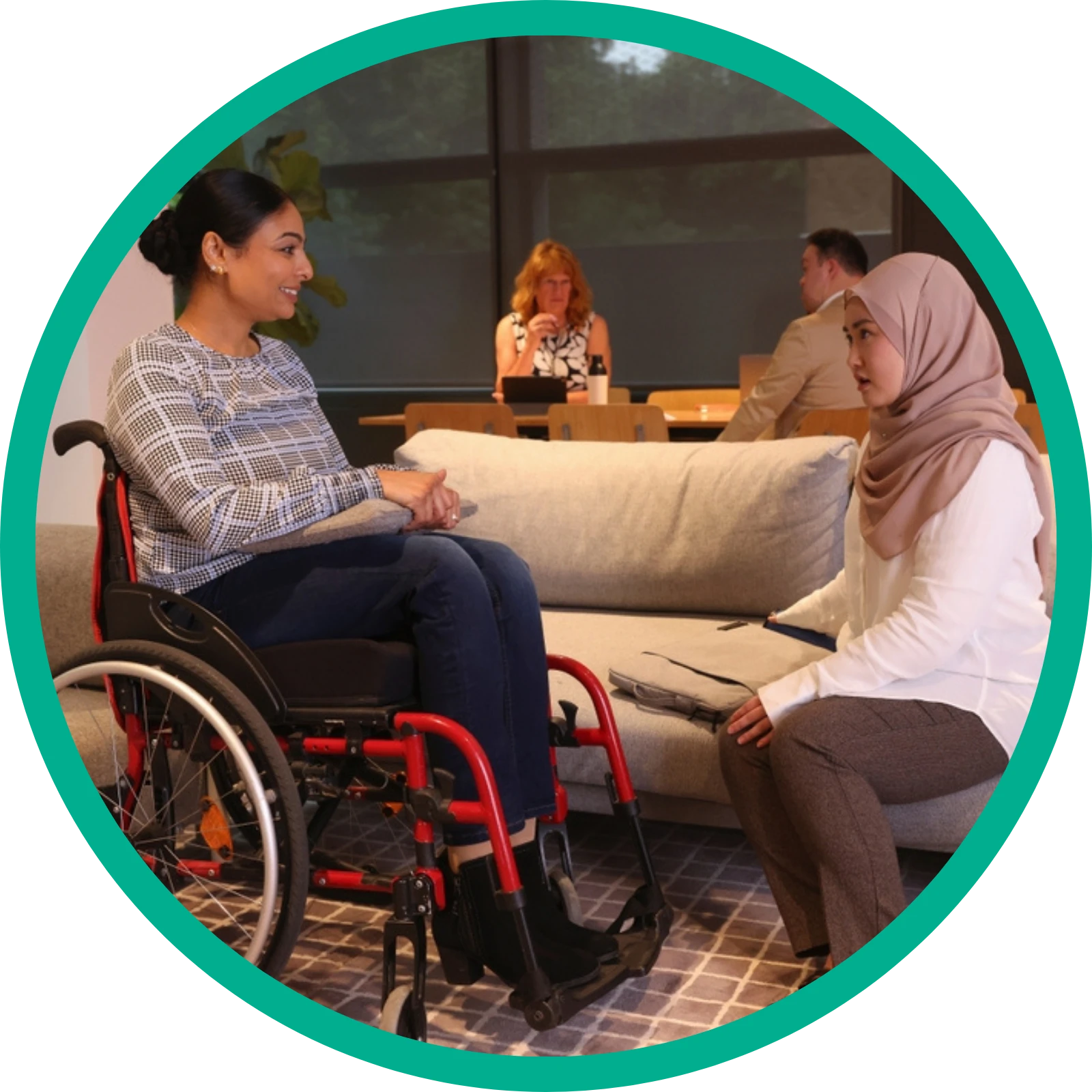 Disabled women on wheelchair looking at caretaker